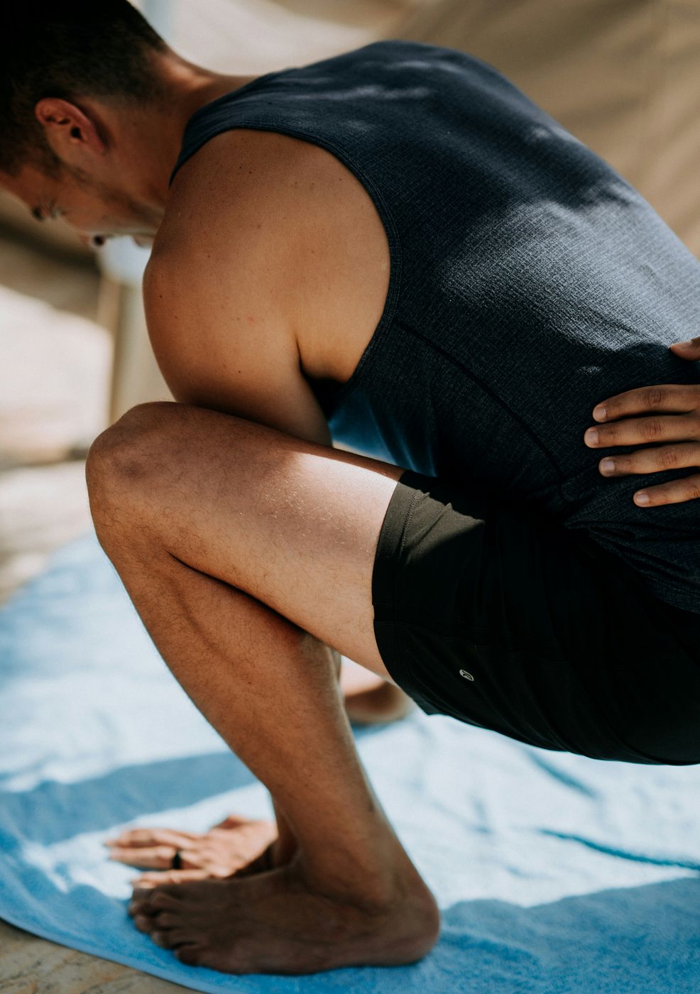 Guided squat assessment with a hand on the lower back